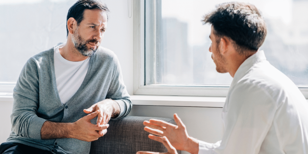 Two men engaged in a discussion in an office, likely about Career Counselling and professional development.