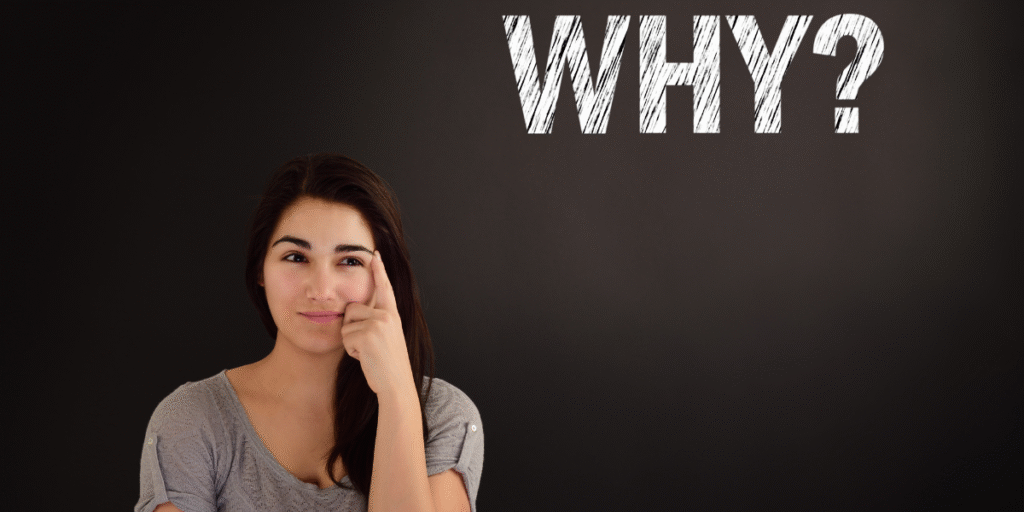 Woman standing in front of a blackboard, pondering the question "Why?" related to learning digital marketing in Gandhinagar.